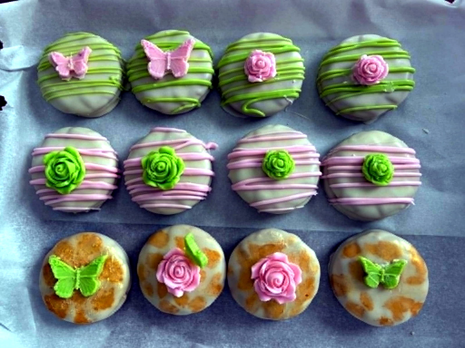 Decorated chocolate dipped Oreos with pink roses and green butterflies