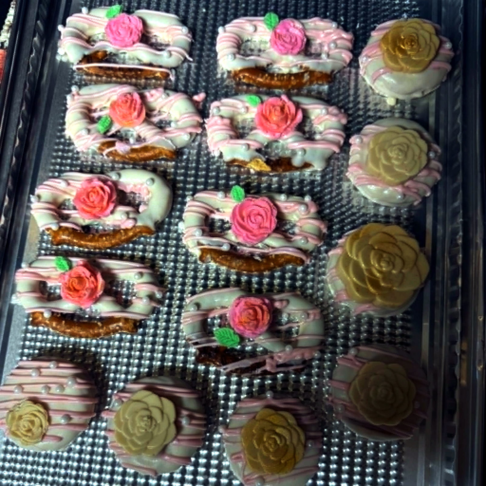 Chocolate dipped pretzels and Oreos topped with floral details