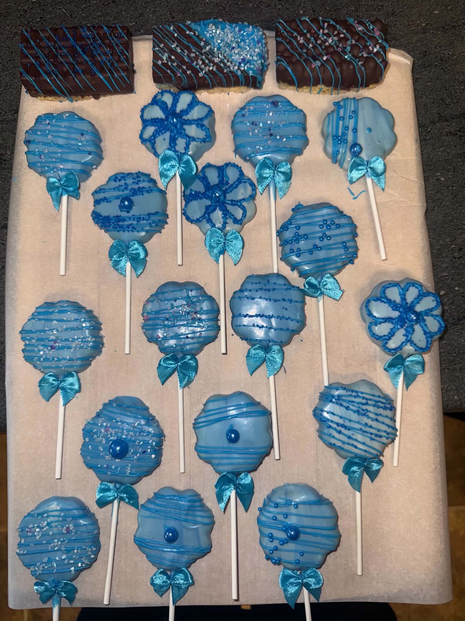 Blue decorated cake pops arranged on a tray